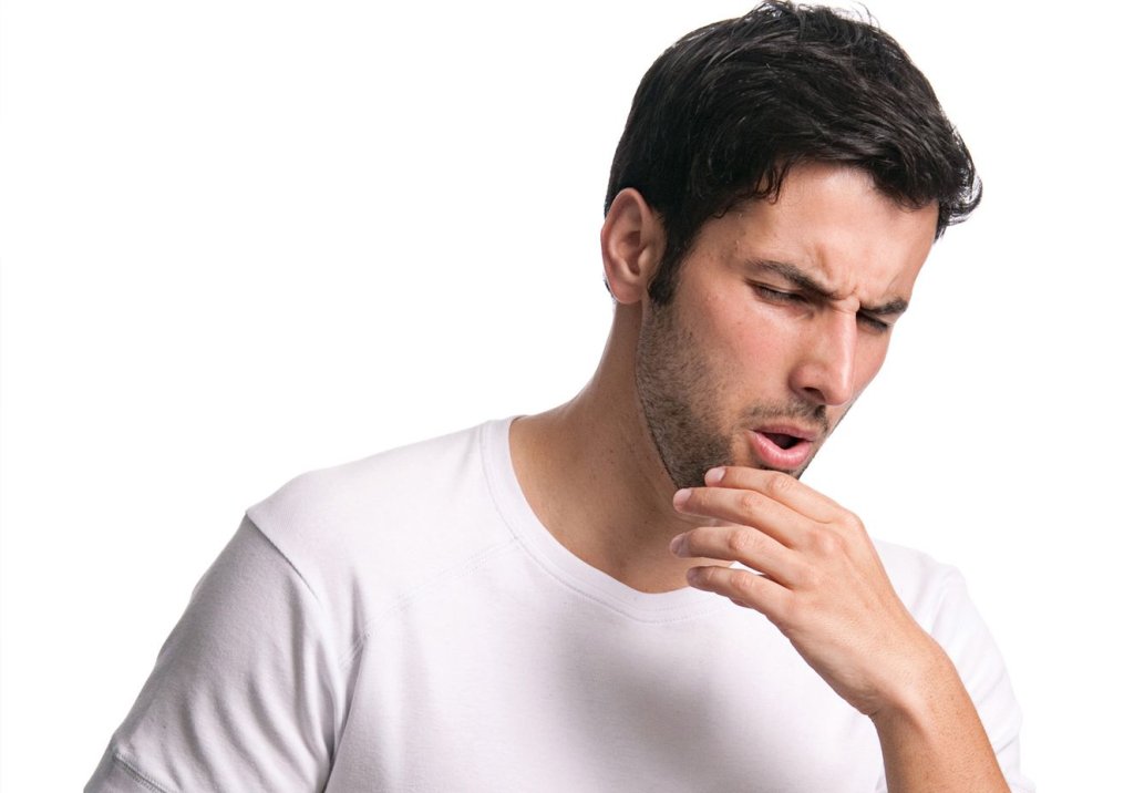 Foto de homem tossindo, um sintoma da tuberculose